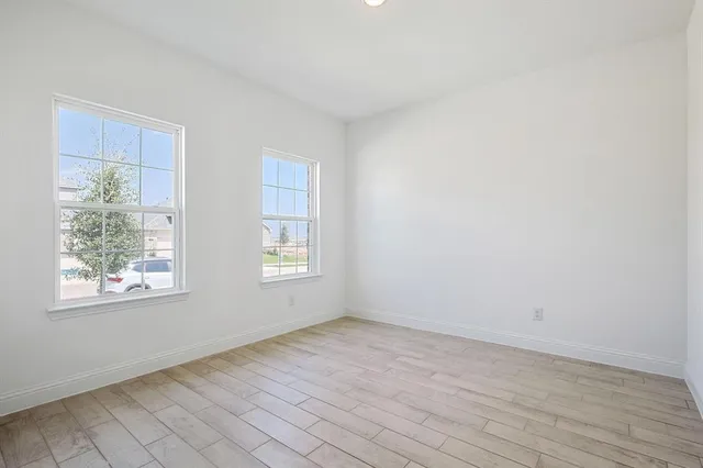 a dining room with furniture potted plants and wooden floor