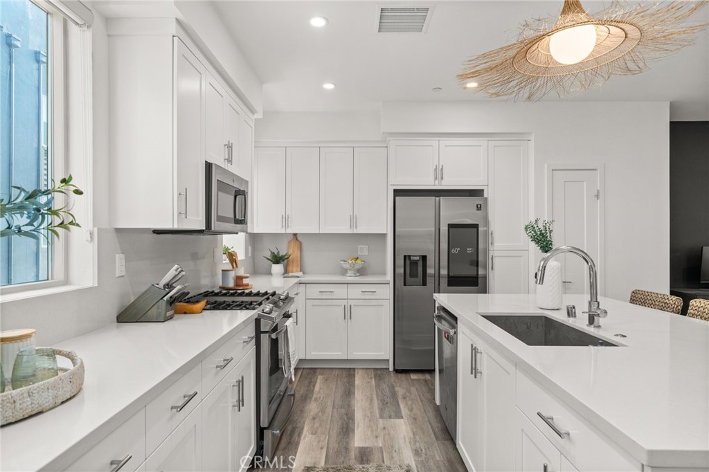 217 Placemark Irvine, CA 92614 - Photo 14 of 39 a kitchen with a sink a stove and cabinets