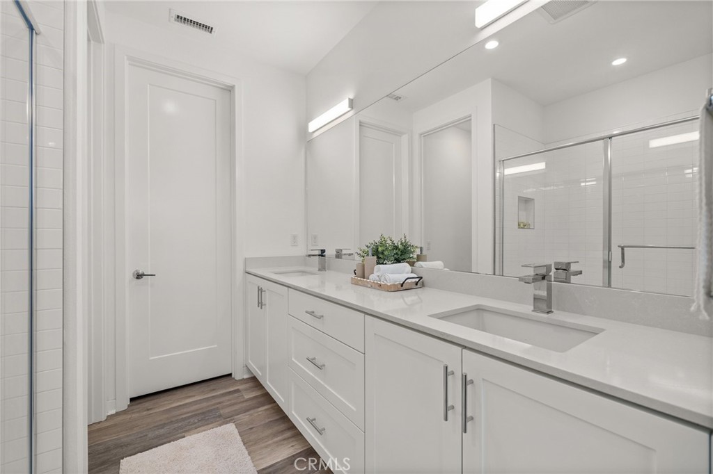 217 Placemark Irvine, CA 92614 - Photo 19 of 39 a bathroom with a granite countertop sink and a mirror