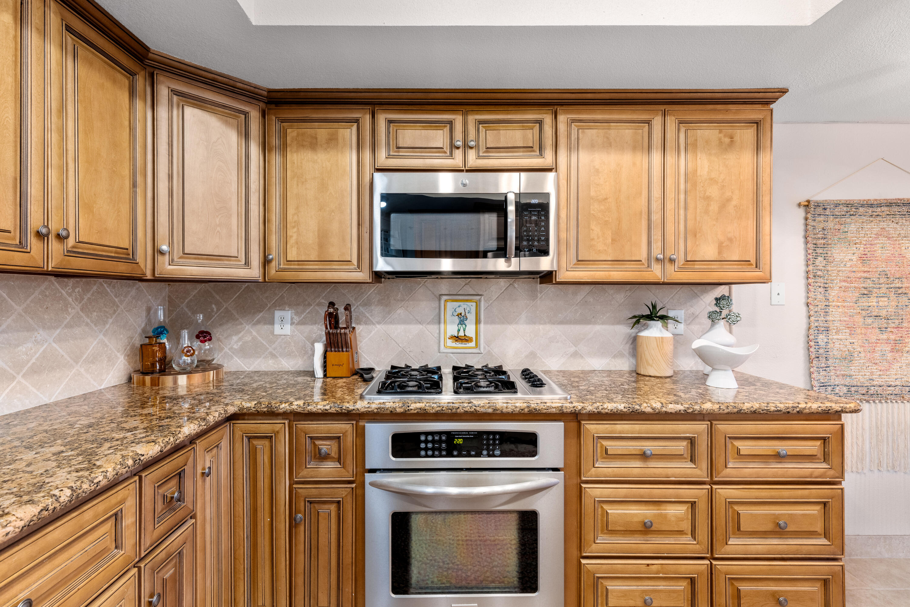 71828 Eleanora Lane Rancho Mirage, CA 92270 - Photo 13 of 37 a kitchen with granite countertop a stove a sink and a microwave