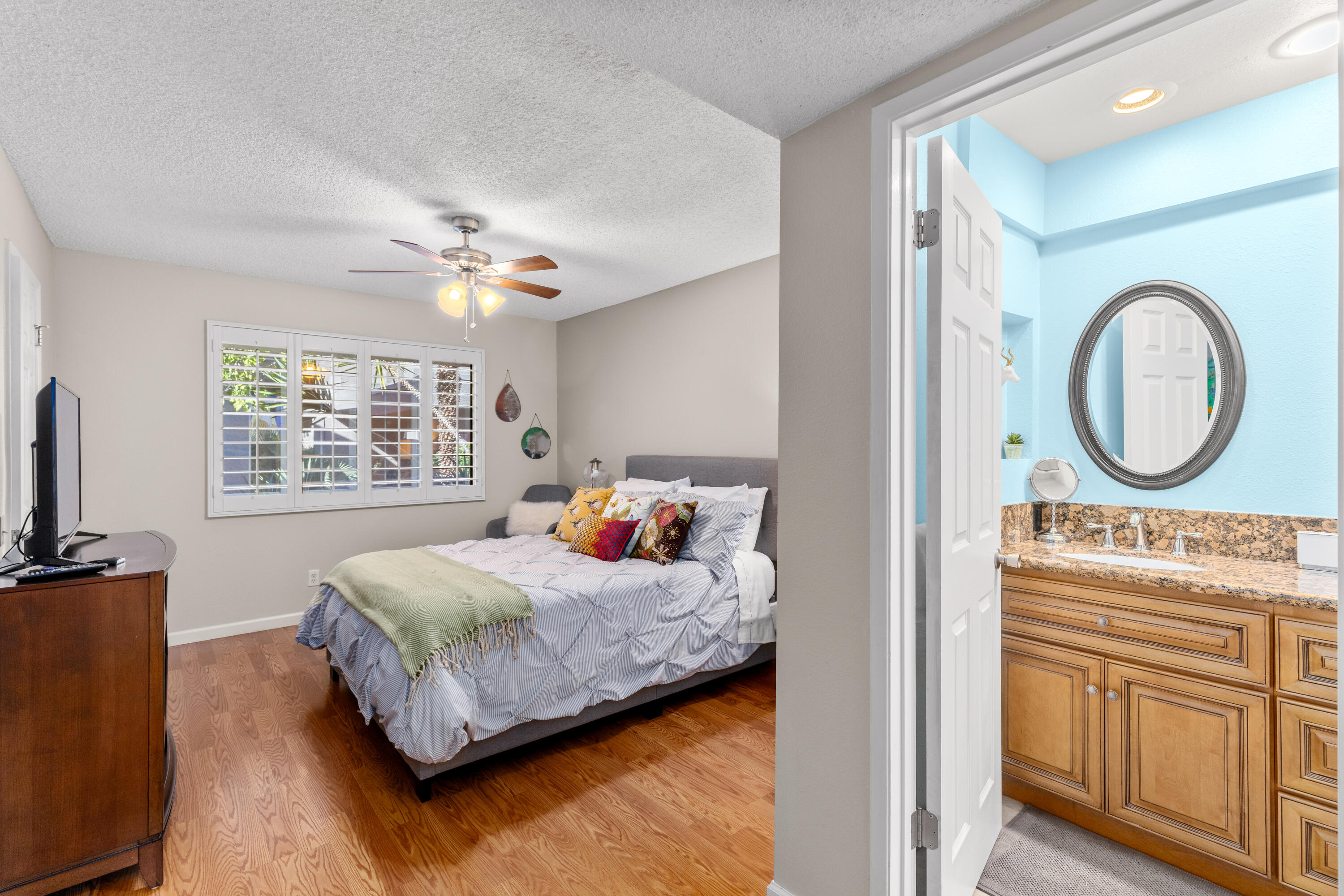 71828 Eleanora Lane Rancho Mirage, CA 92270 - Photo 15 of 37 a bedroom with a bed a mirror and a window