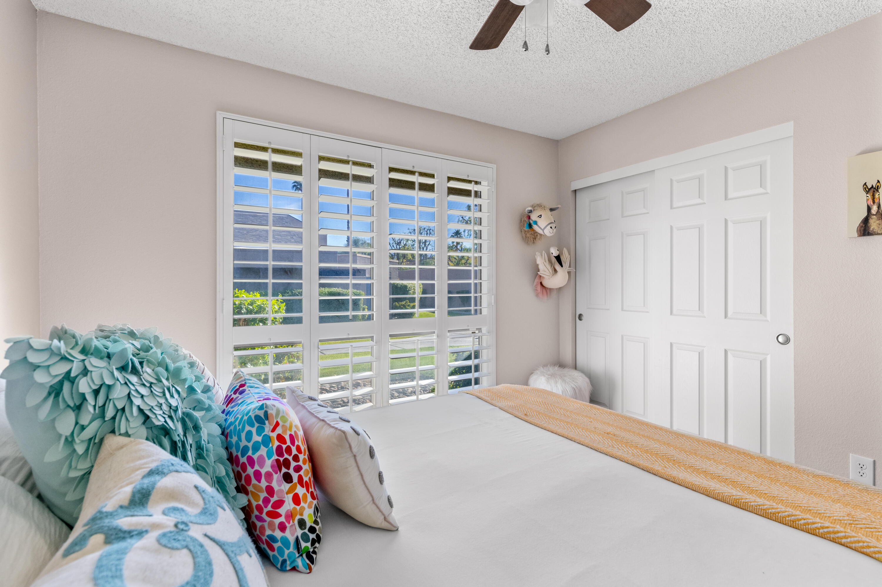 71828 Eleanora Lane Rancho Mirage, CA 92270 - Photo 23 of 37 a bedroom with a bed and a large window