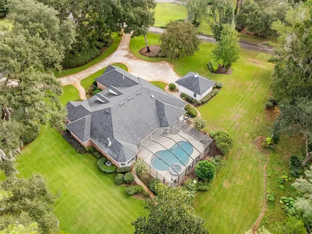 an aerial view of a house with a yard basket ball court and outdoor seating