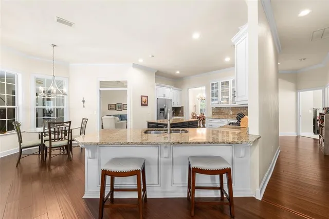 a dining room with furniture and wooden floor
