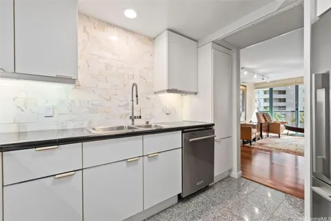 a kitchen with granite countertop a sink and a stove