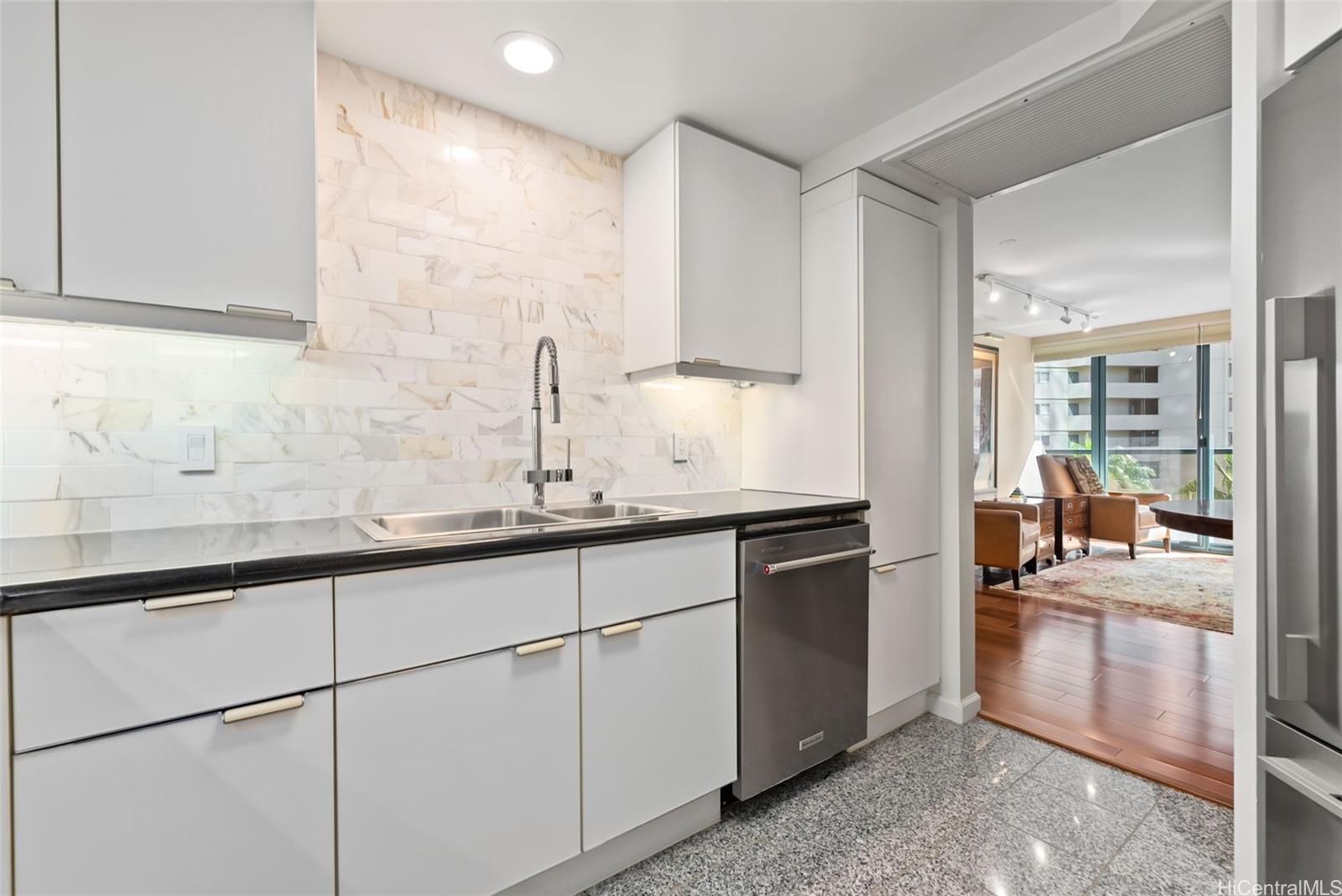 1888 Kalakaua Avenue, Unit 907 Honolulu, HI 96815 - Photo 1 of 25 a kitchen with granite countertop a sink and a stove