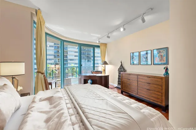 a bedroom with a large bed and a window