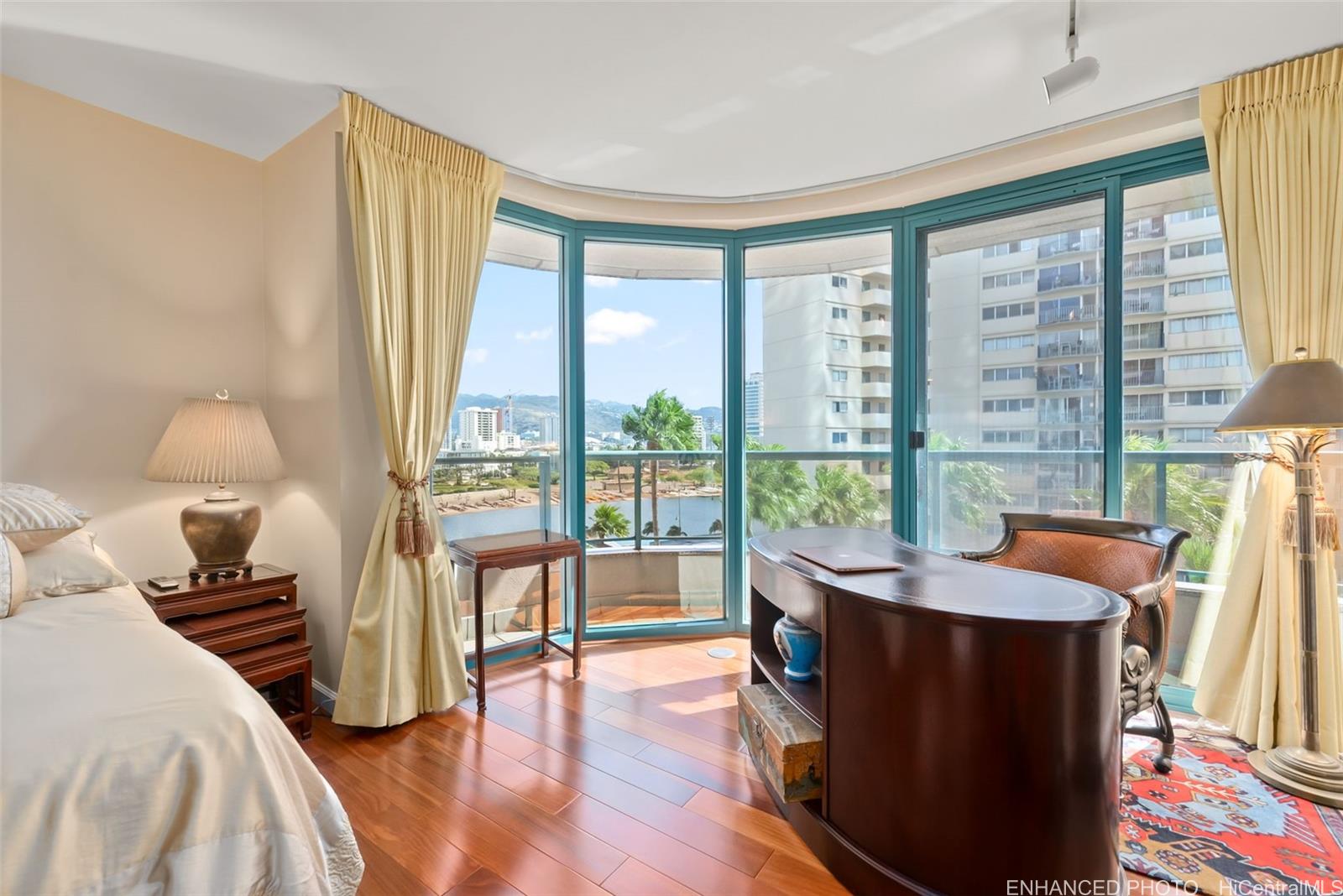 1888 Kalakaua Avenue, Unit 907 Honolulu, HI 96815 - Photo 14 of 25 a living room with furniture and a large window