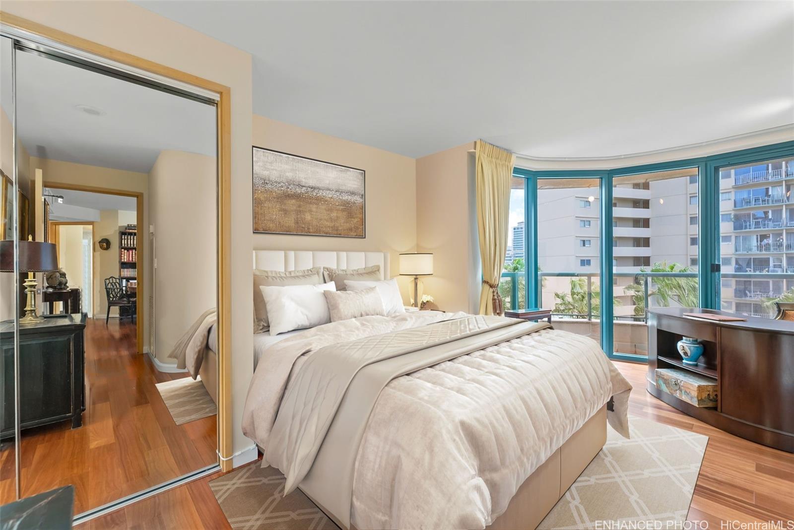 1888 Kalakaua Avenue, Unit 907 Honolulu, HI 96815 - Photo 15 of 25 a bedroom with a large bed and a large window