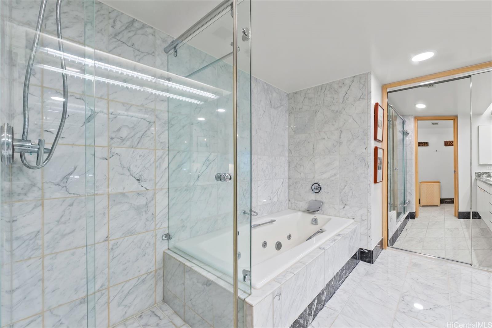1888 Kalakaua Avenue, Unit 907 Honolulu, HI 96815 - Photo 16 of 25 a bathroom with a bathtub and a shower