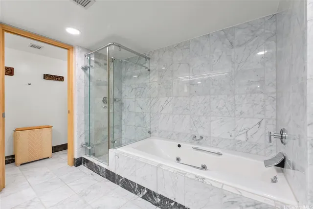 a bathroom with a bathtub and a shower