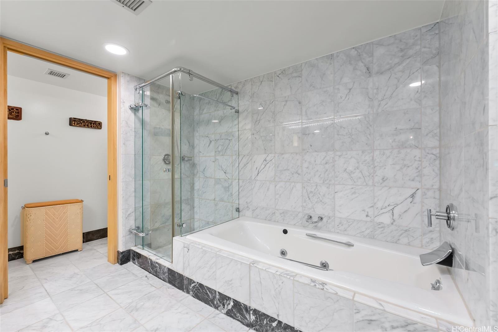 1888 Kalakaua Avenue, Unit 907 Honolulu, HI 96815 - Photo 18 of 25 a bathroom with a bathtub and a shower