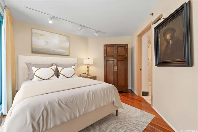 a bedroom with a bed and a painting on the wall