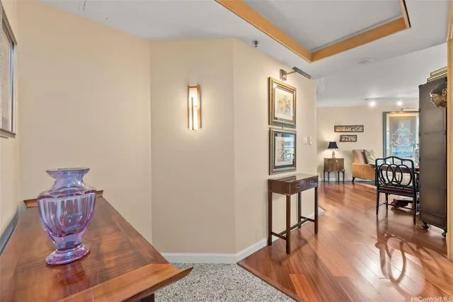 a living room with furniture a wooden floor and next to a window