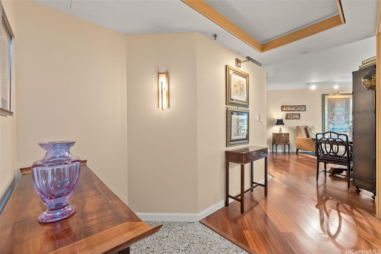 1888 Kalakaua Avenue, Unit 907 Honolulu, HI 96815 - Photo 2 of 25 a living room with furniture a wooden floor and next to a window