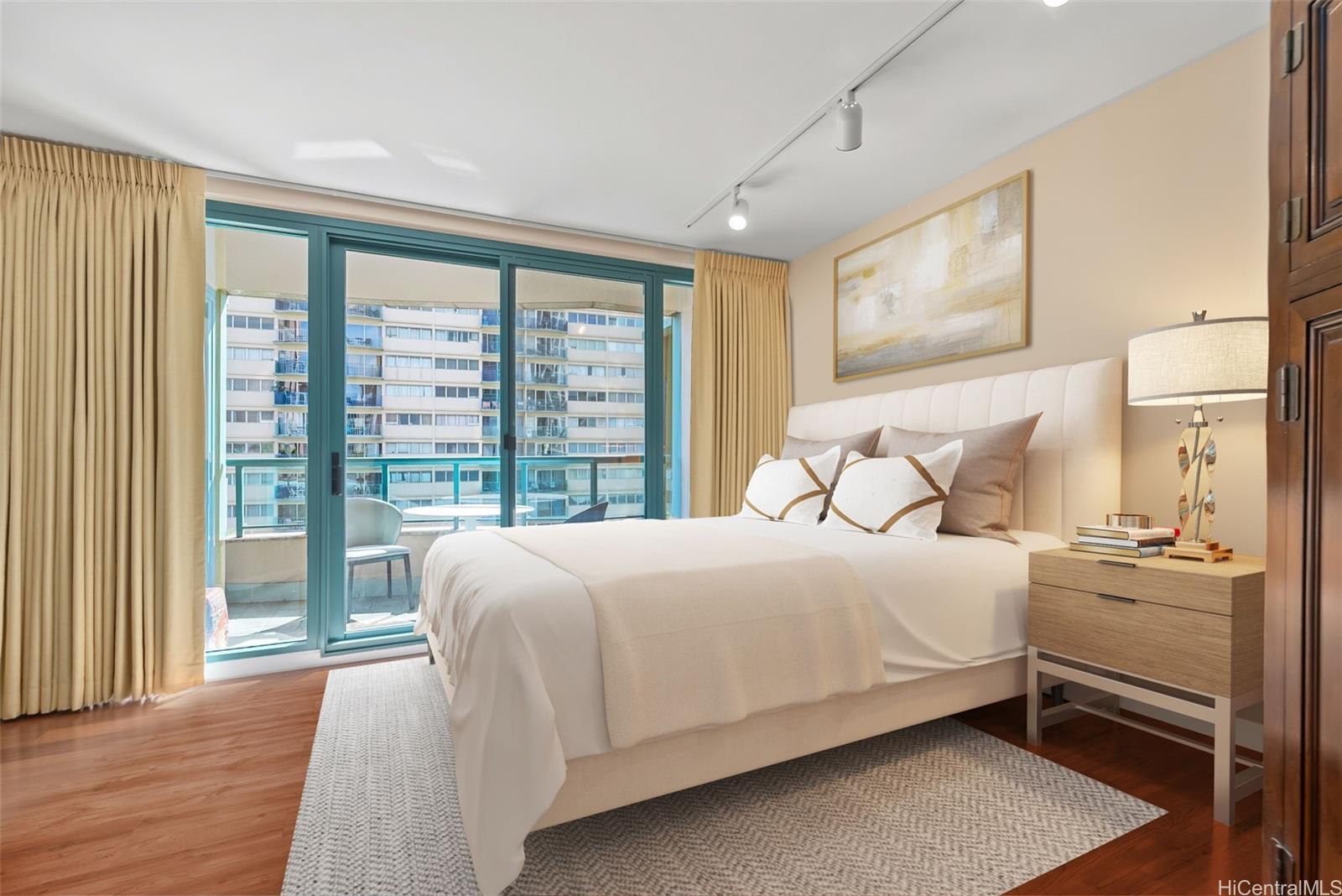 1888 Kalakaua Avenue, Unit 907 Honolulu, HI 96815 - Photo 21 of 25 a bedroom with a bed and wooden floor