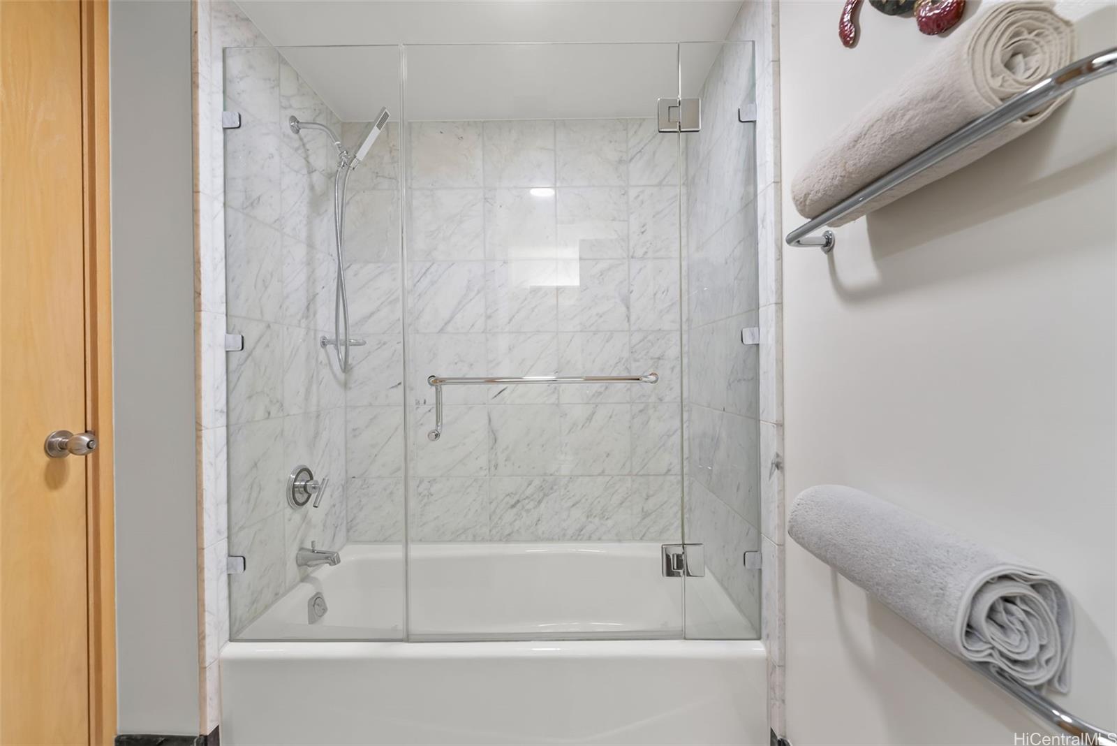 1888 Kalakaua Avenue, Unit 907 Honolulu, HI 96815 - Photo 22 of 25 a bathroom with a bathtub and a shower