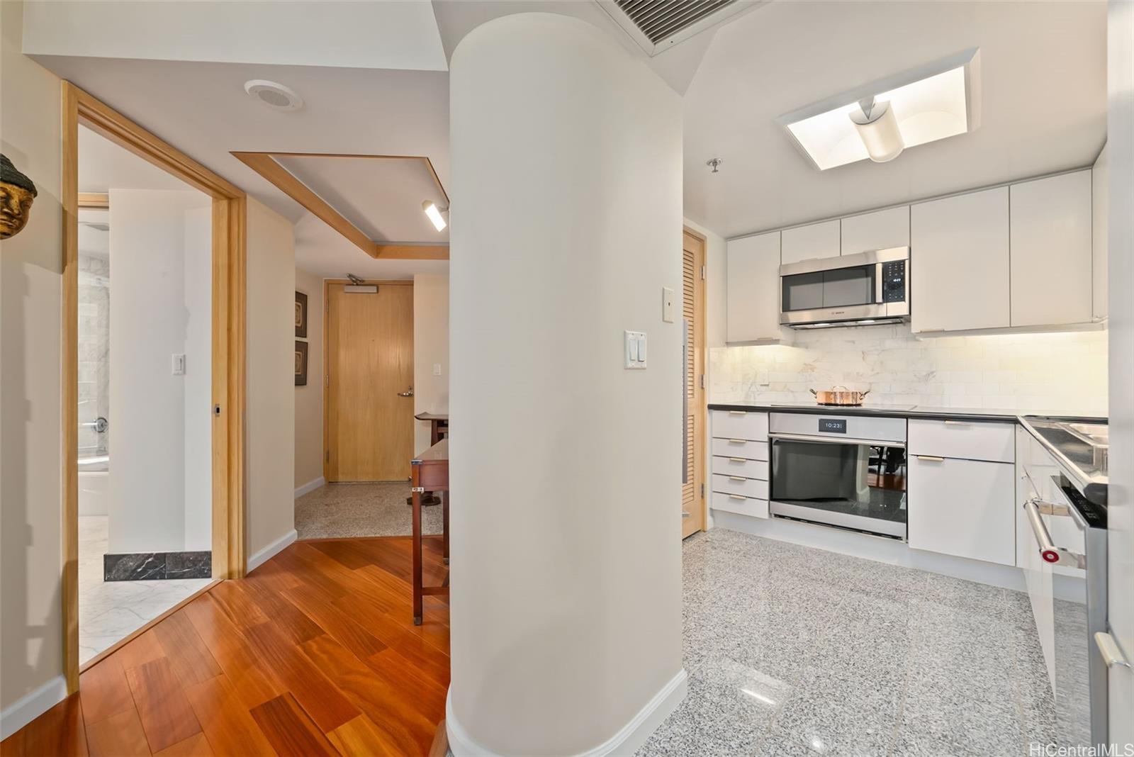 1888 Kalakaua Avenue, Unit 907 Honolulu, HI 96815 - Photo 3 of 25 a kitchen with stainless steel appliances granite countertop a stove and a refrigerator