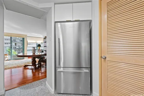 a kitchen with stainless steel appliances a refrigerator and wooden floor