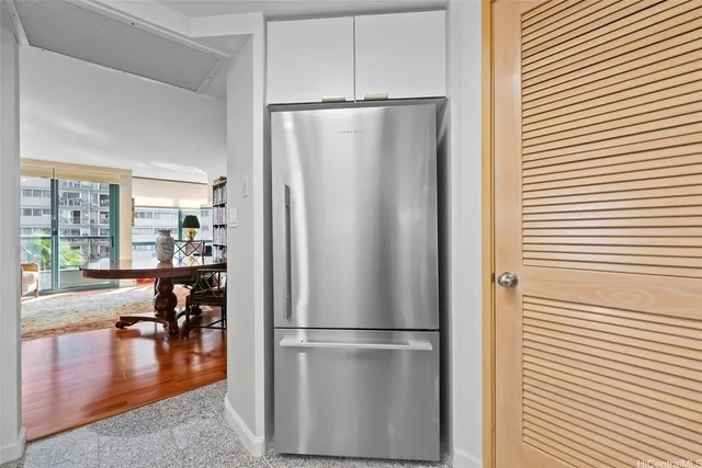 a kitchen with stainless steel appliances a refrigerator and wooden floor