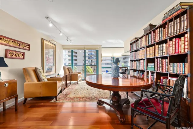 a living room with furniture and a book shelf