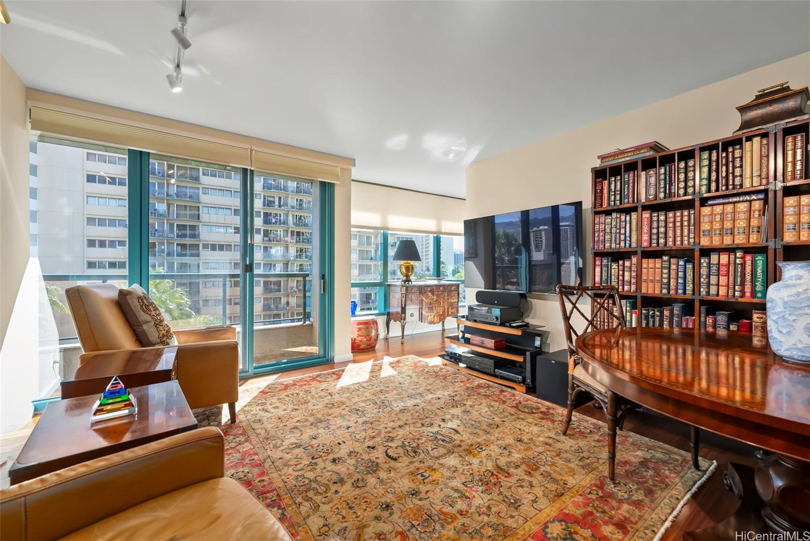 1888 Kalakaua Avenue, Unit 907 Honolulu, HI 96815 - Photo 10 of 25 a bed room with furniture and a book shelf