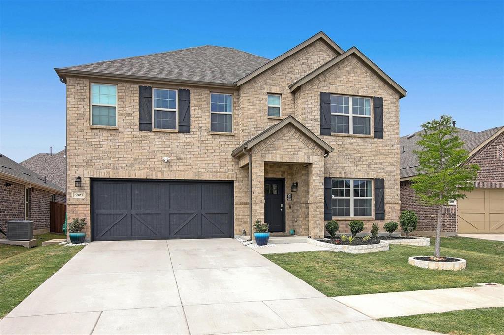 5821 Rostherne Drive Aubrey, TX 76227 - Photo 1 of 21 a front view of a house with a yard and garage