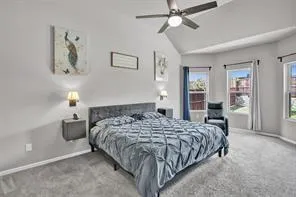 a bedroom with a bed and ceiling fan