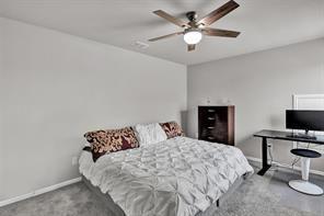 5821 Rostherne Drive Aubrey, TX 76227 - Photo 16 of 21 a bedroom with a bed and a chandelier