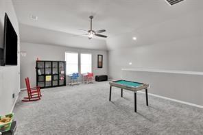 5821 Rostherne Drive Aubrey, TX 76227 - Photo 18 of 21 a living room with furniture and a flat screen tv