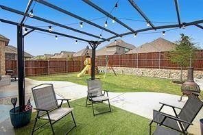 5821 Rostherne Drive Aubrey, TX 76227 - Photo 20 of 21 a view of a chair and table in the patio