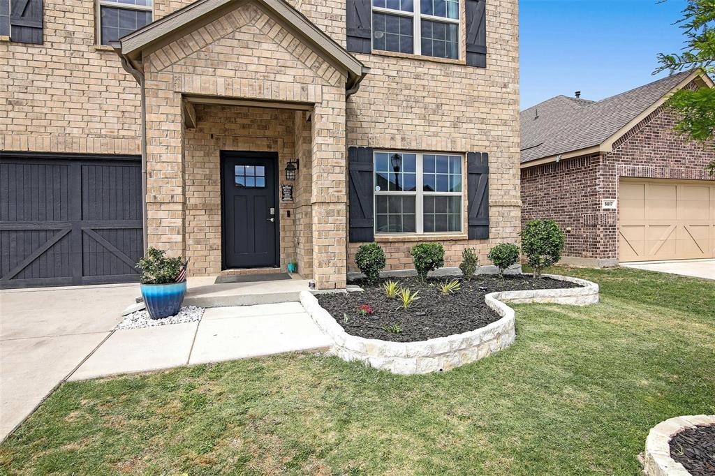5821 Rostherne Drive Aubrey, TX 76227 - Photo 2 of 21 a front view of a house with garden