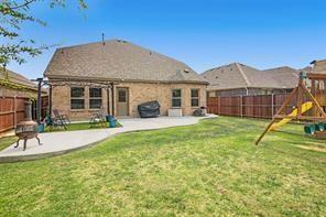 5821 Rostherne Drive Aubrey, TX 76227 - Photo 21 of 21 a view of a house with a yard and sitting area