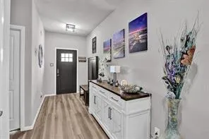 a kitchen with stainless steel appliances a white stove top oven and a potted plant