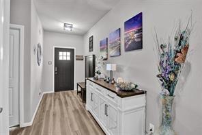 5821 Rostherne Drive Aubrey, TX 76227 - Photo 5 of 21 a kitchen with stainless steel appliances a white stove top oven and a potted plant