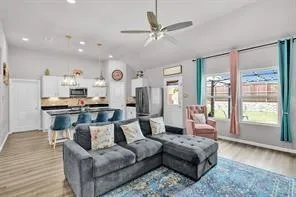 a living room with furniture and a large window