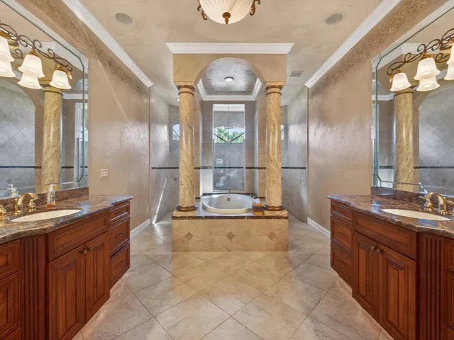 a large spacious bathroom with a double vanity sink a mirror and a bathtub