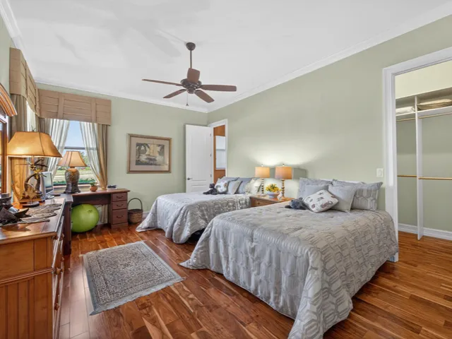 a bedroom with two beds and painting on the wall