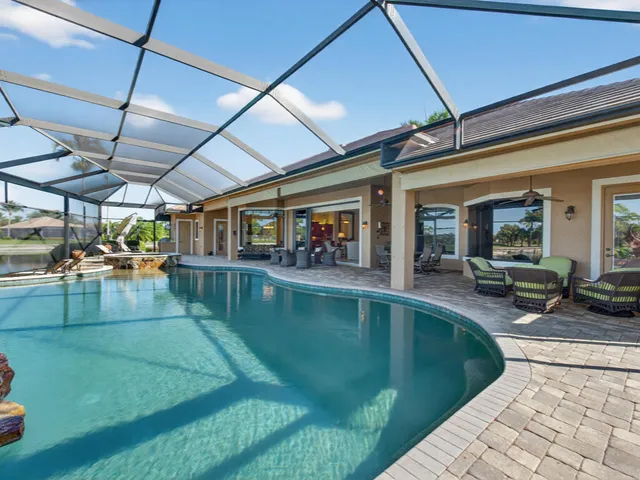 a view of a swimming pool with sitting area