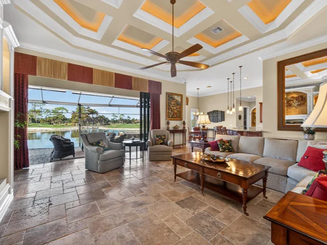 a living room with patio furniture and a floor to ceiling window