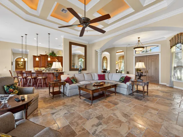 a living room with furniture and a chandelier
