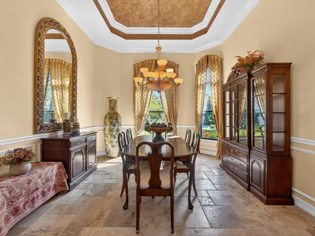 a dining room with furniture a chandelier and a rug