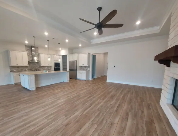 a view of a kitchen with a sink and wooden floor