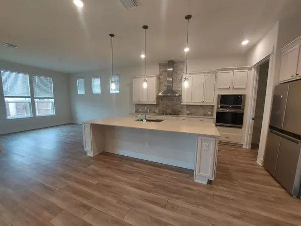 a view of kitchen and sink with wooden floor