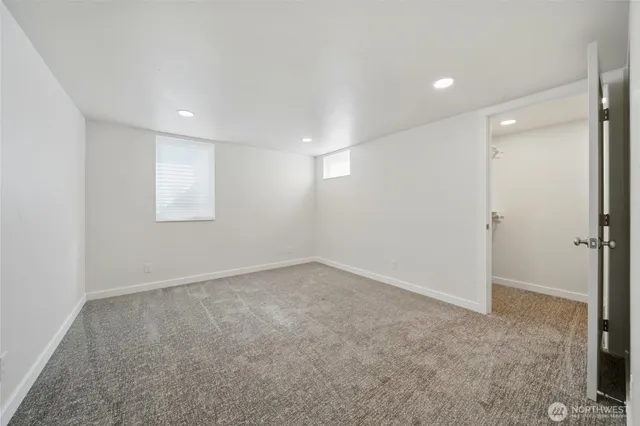 an empty room with a empty space and windows