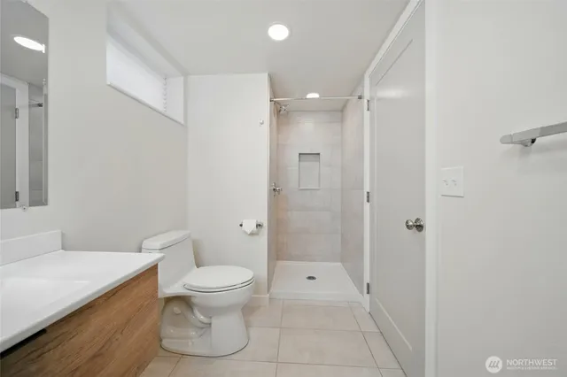 a bathroom with a toilet a sink and shower