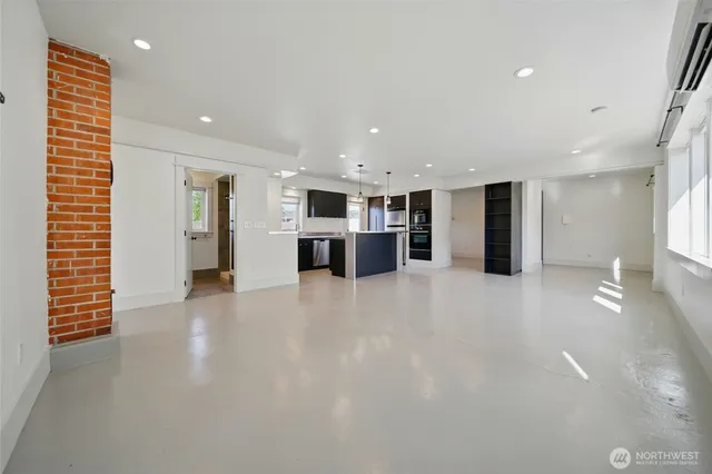 a view of a kitchen with a refrigerator and a large window
