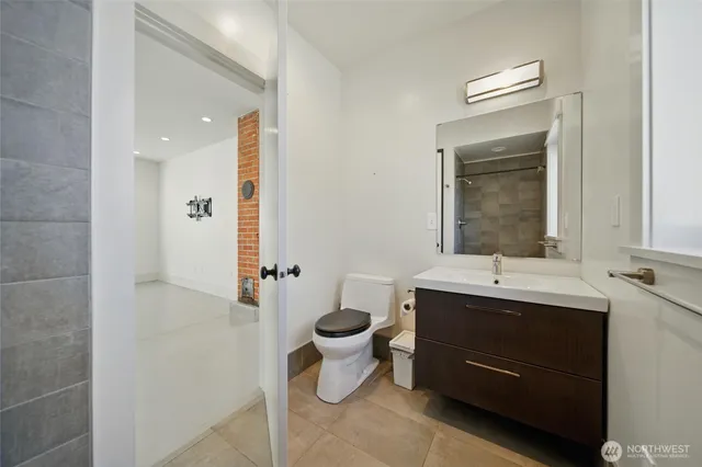 a bathroom with a toilet sink and mirror