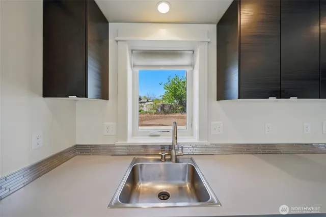 a bathroom with a sink and a window