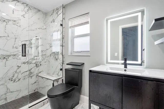 a bathroom with a toilet sink and mirror